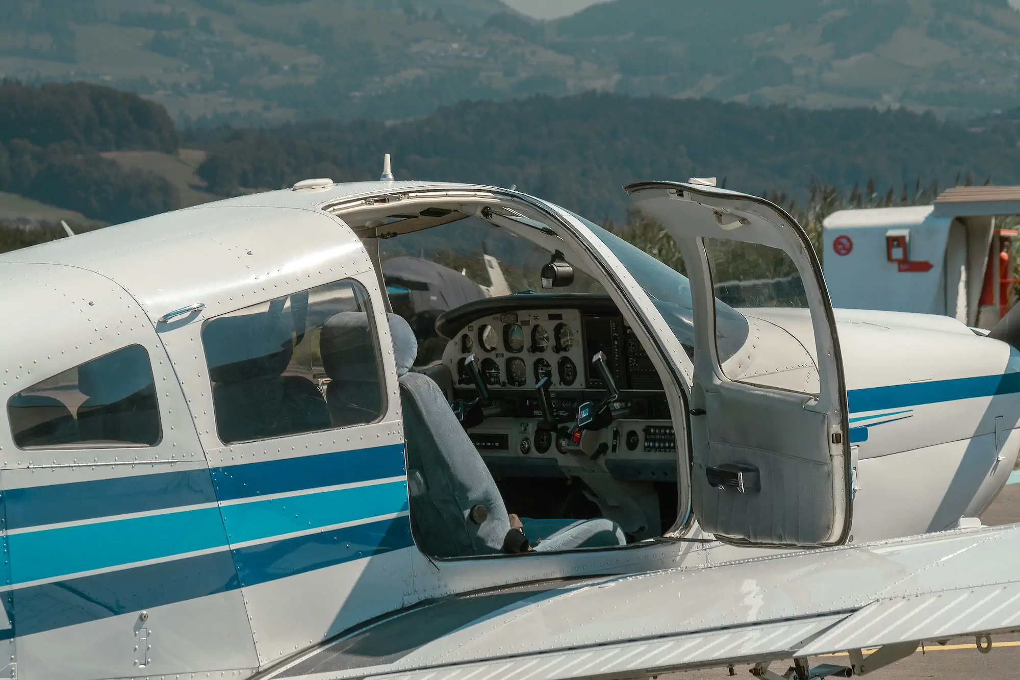 Piston single on the ramp with cabin door open