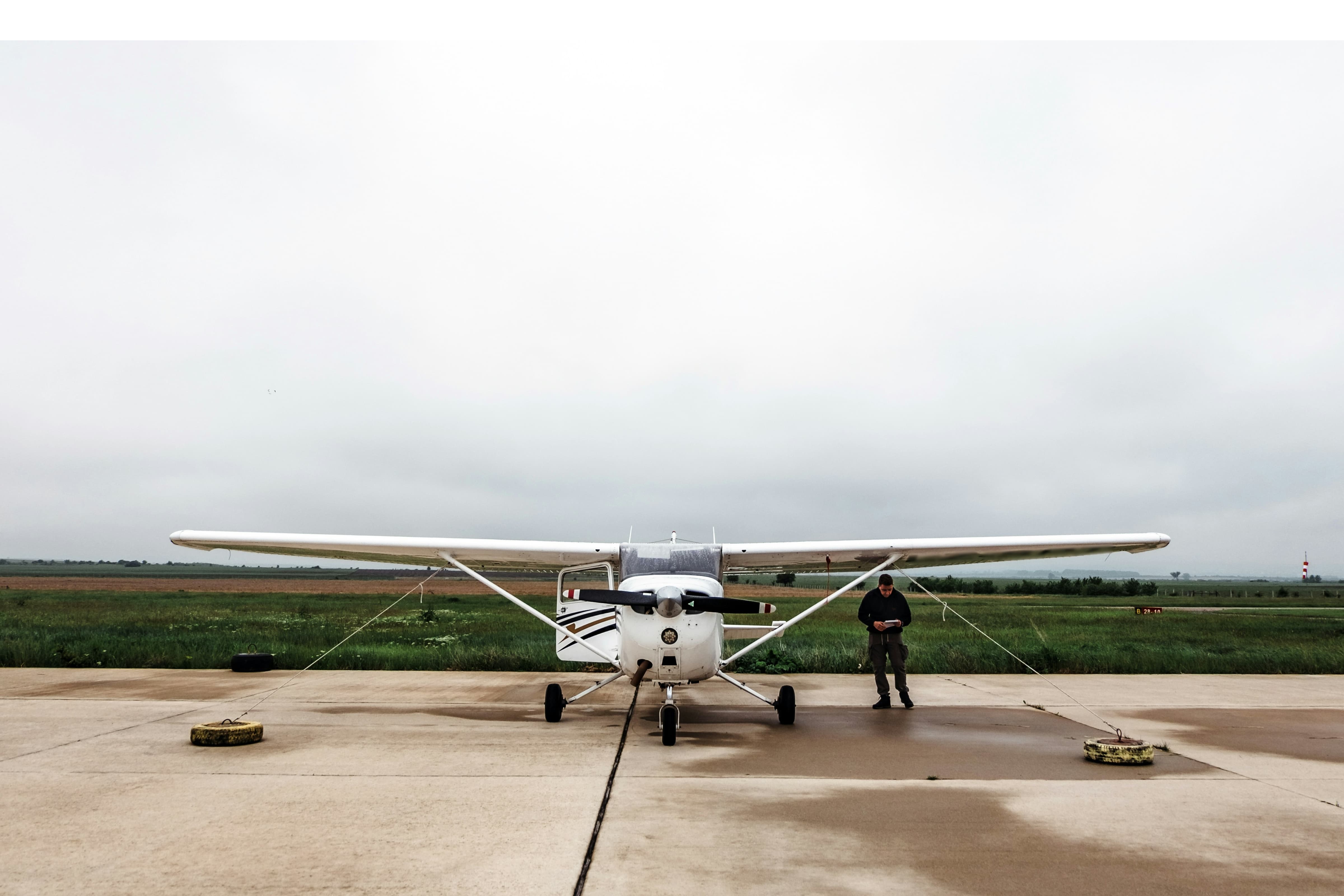 Pilot conducts preflight checklist on a Cessna