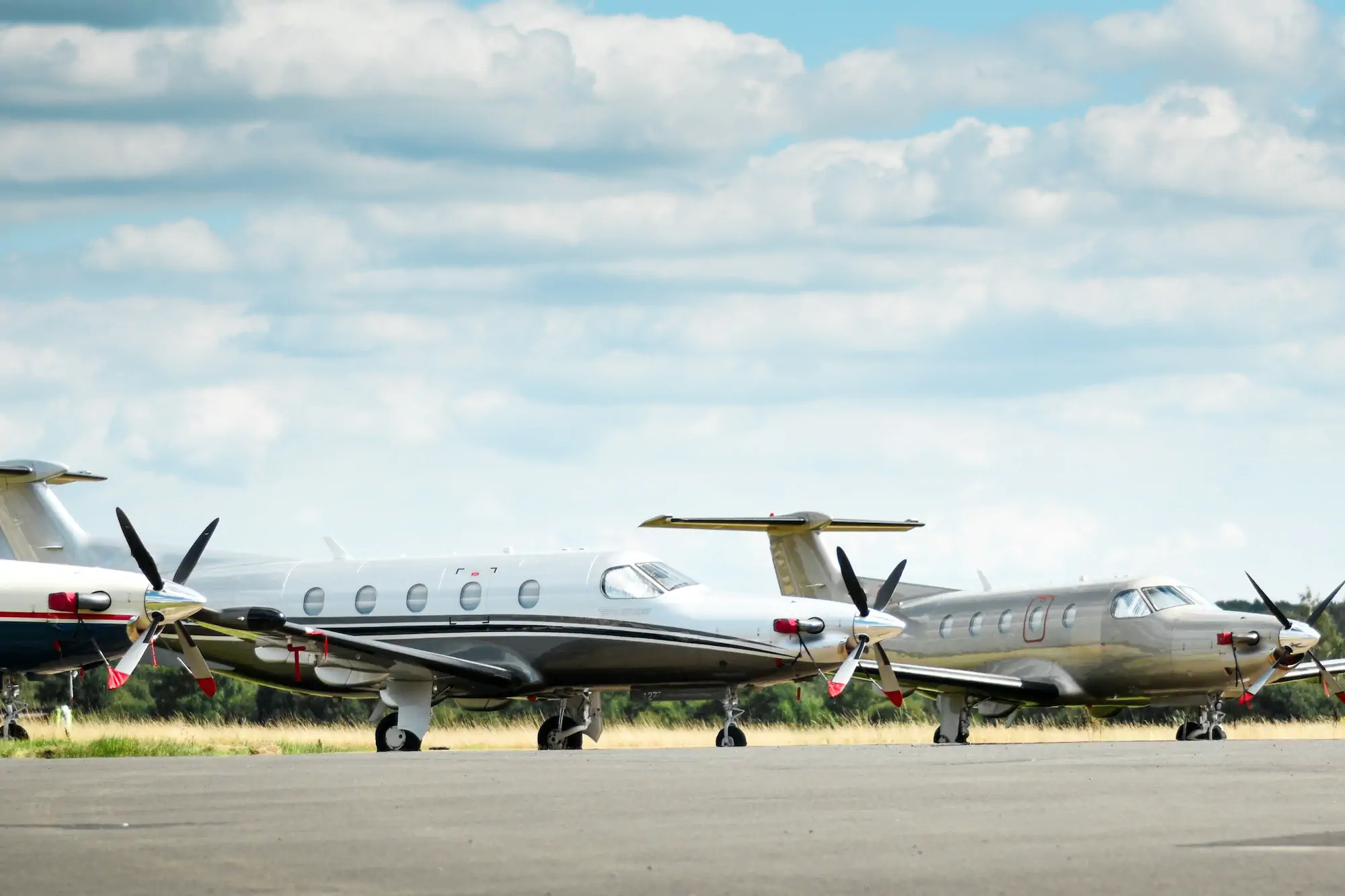 Three Pilatus PC-12 aircraft on the ramp