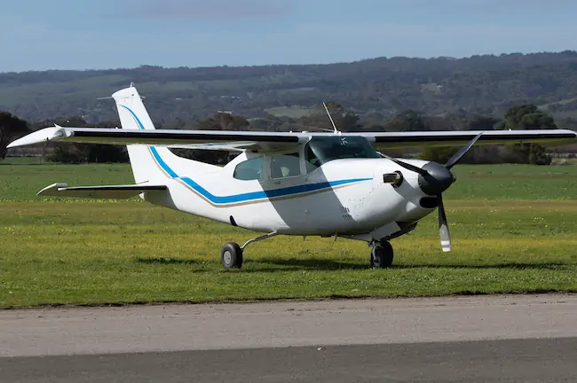 Cessna 210 parked in a field