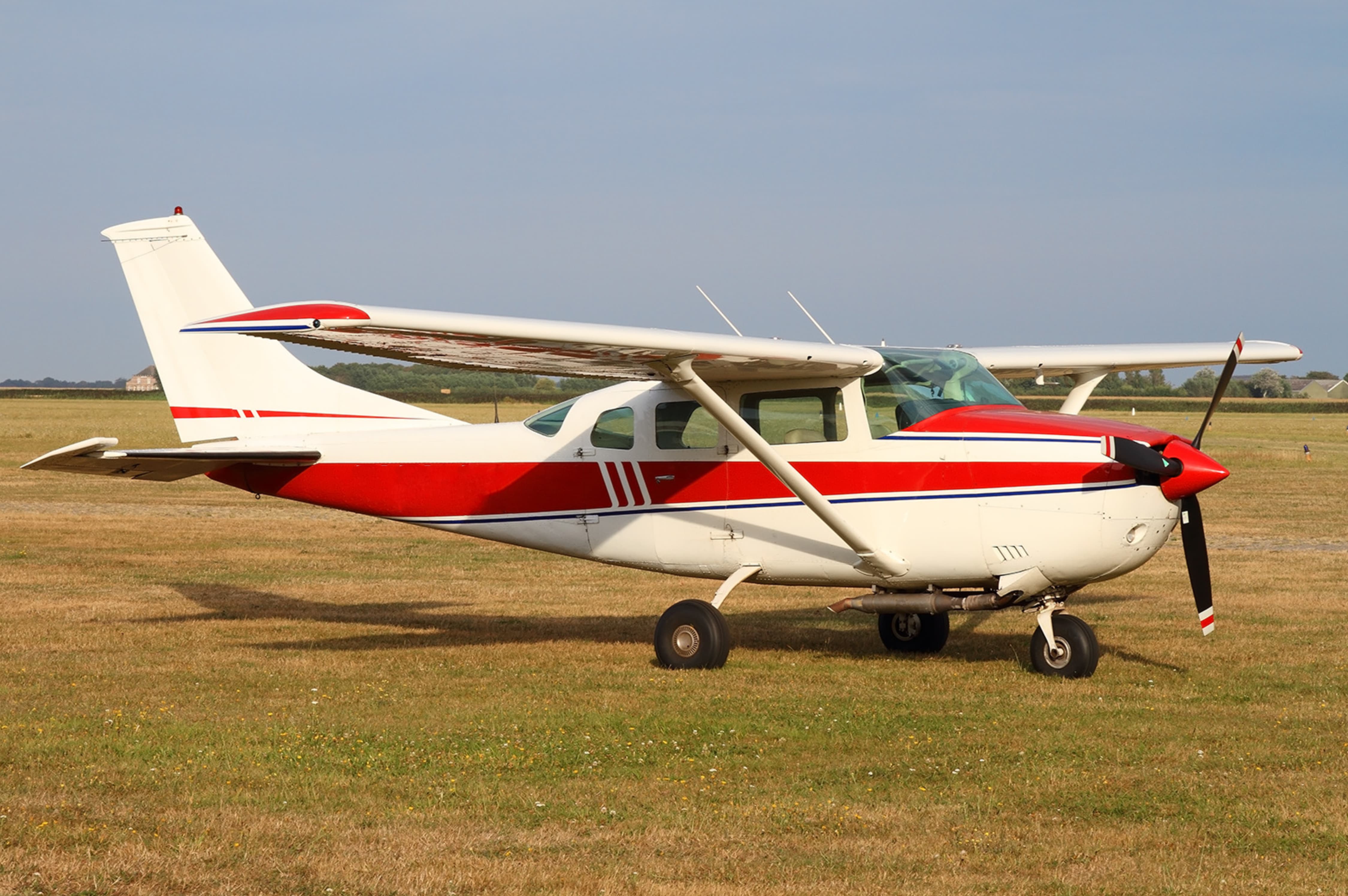 Cessna 206 parked in a field