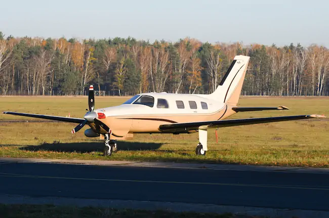 Piper PA-46 parked in the grass