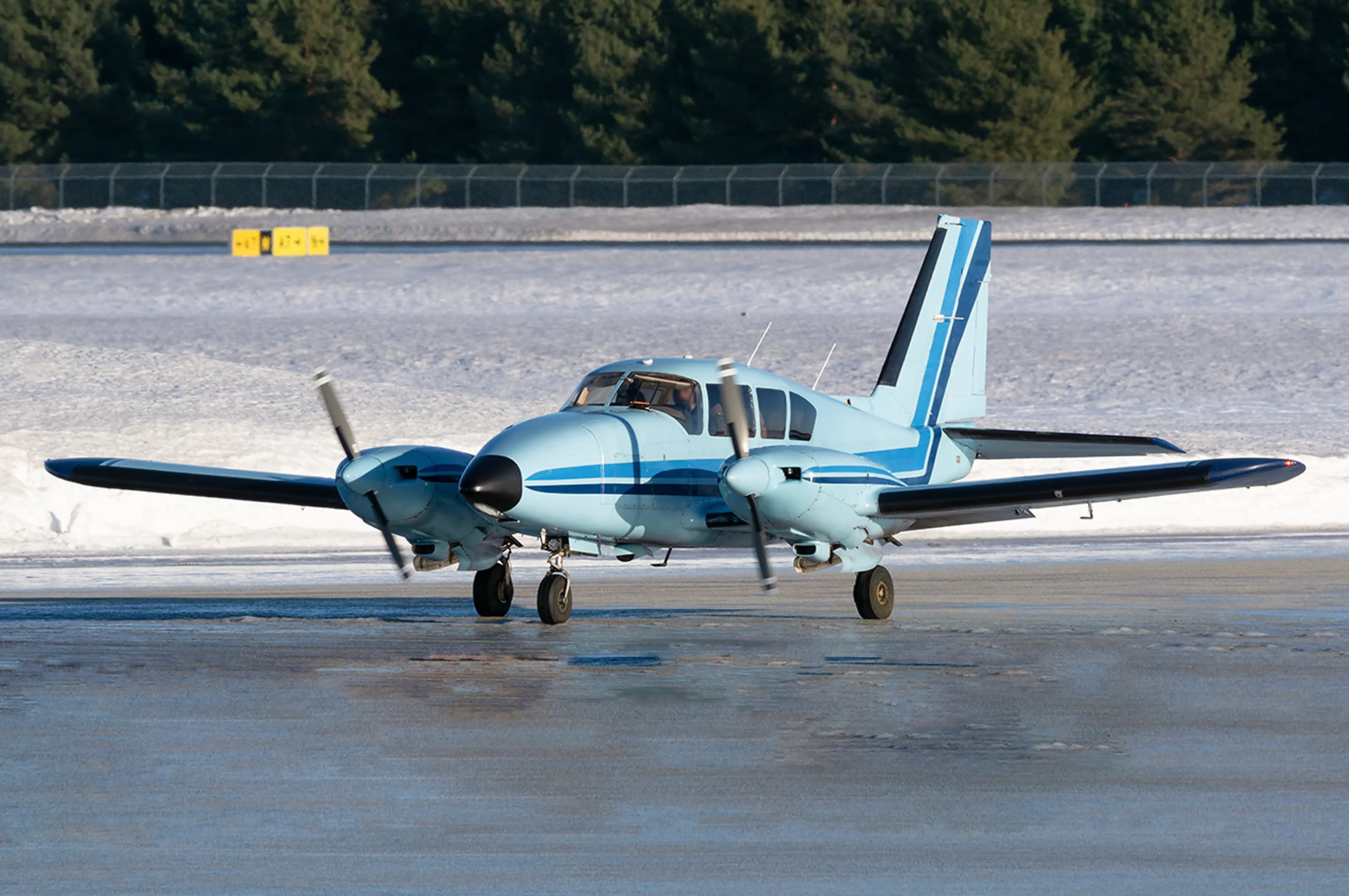 Piper PA-23 taxiing on the ramp
